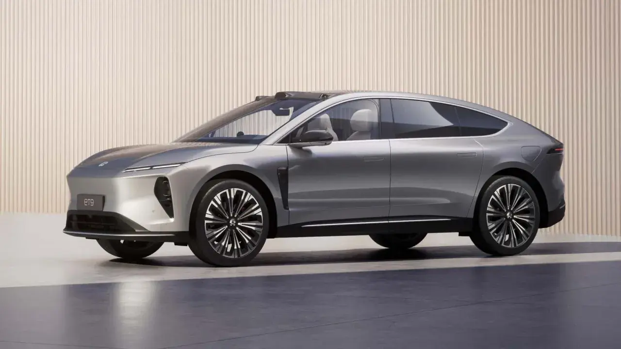 Nio ET9, un'elegante berlina coupé grigia, mostra un design futuristico con linee aerodinamiche e cerchi sportivi.