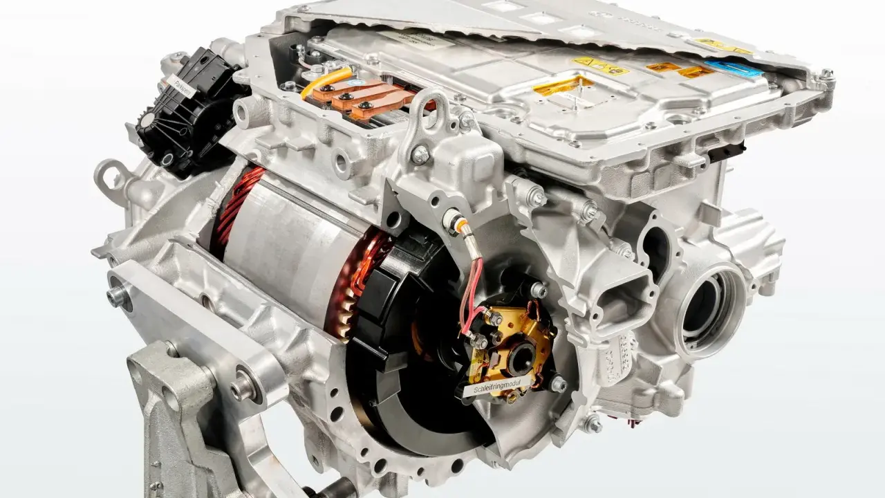 Cutaway view of an electric car motor, showing internal components like the rotor, stator, and power electronics.