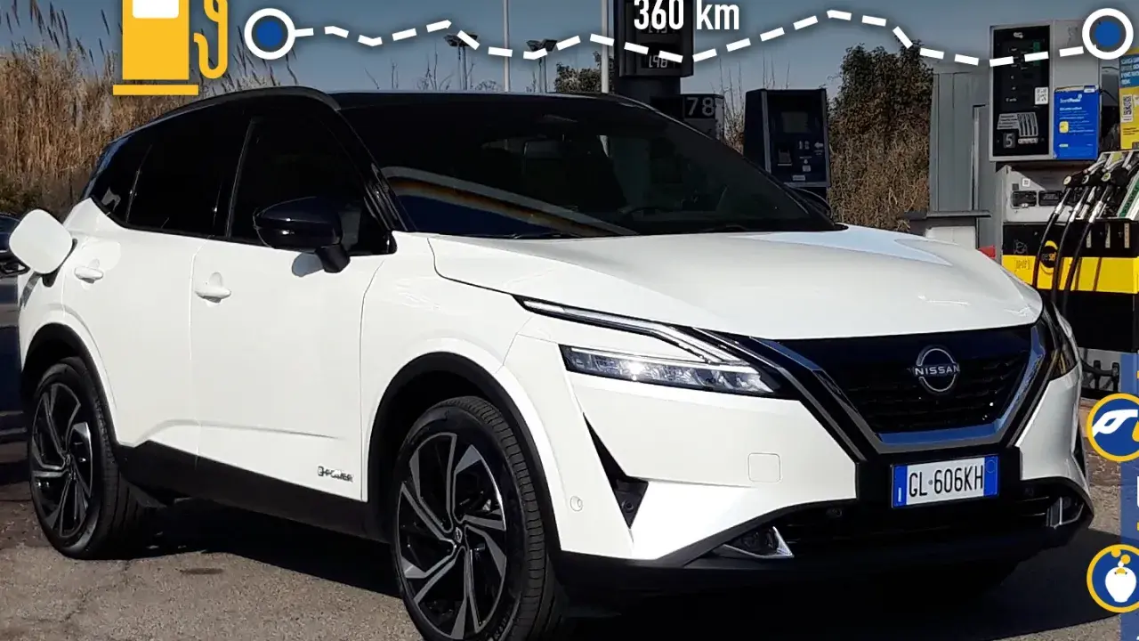 Nissan Qashqai e-POWER: potenza e autonomia per 360 km. L'auto è bianca, con tetto nero, e si trova vicino a una colonnina di ricarica.