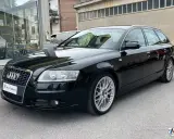 Audi A6 C6 Avant nera, elegante e sportiva, con cerchi in lega argentati.