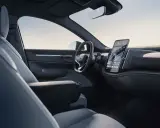 Interni minimalisti del Volvo EX30: sedili chiari, volante moderno e grande schermo centrale con navigazione.