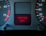 Car dashboard with EPC light on and "SERVICE NOW" message displayed in red.