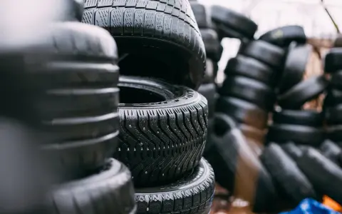 Pile di gomme invernali con chiodi, pronte per affrontare la neve. La sigla gomme invernali è ben visibile sul battistrada.