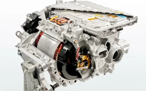 Cutaway view of an electric car motor, showing internal components like the rotor, stator, and power electronics.