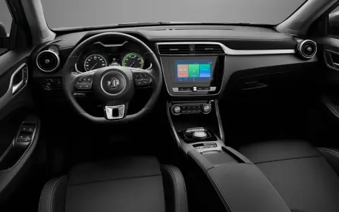 Interni dell'MG ZS: volante multifunzione, cruscotto digitale, schermo touchscreen centrale e sedili in pelle nera.