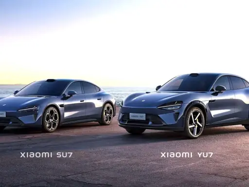 Due auto elettriche Xiaomi, SU7 e YU7, parcheggiate sulla costa al tramonto.