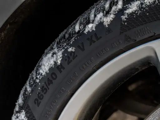 Pneumatici M+S con neve sul battistrada, pronti per affrontare l'inverno.