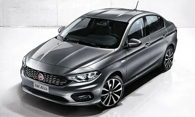 La Fiat Egea grigia, un'elegante berlina, si presenta in uno studio con un design moderno e cerchi sportivi.